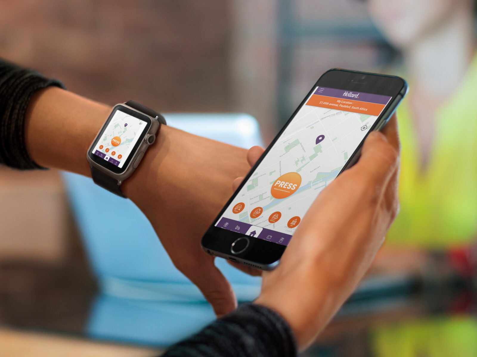 Hollard Help app open on iPhone and Apple Watch, showing the press-for-help map screen